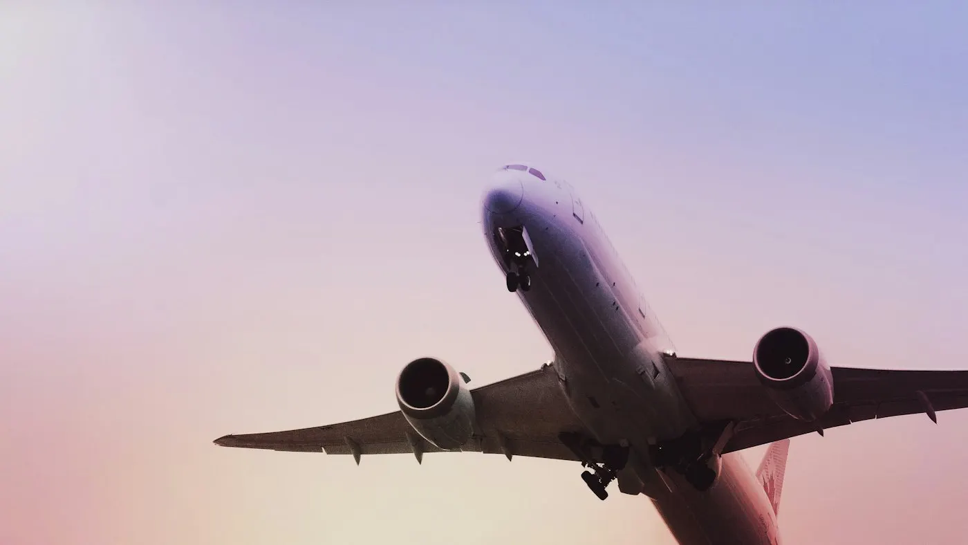 Passenger aircraft taking off against an evening sky
